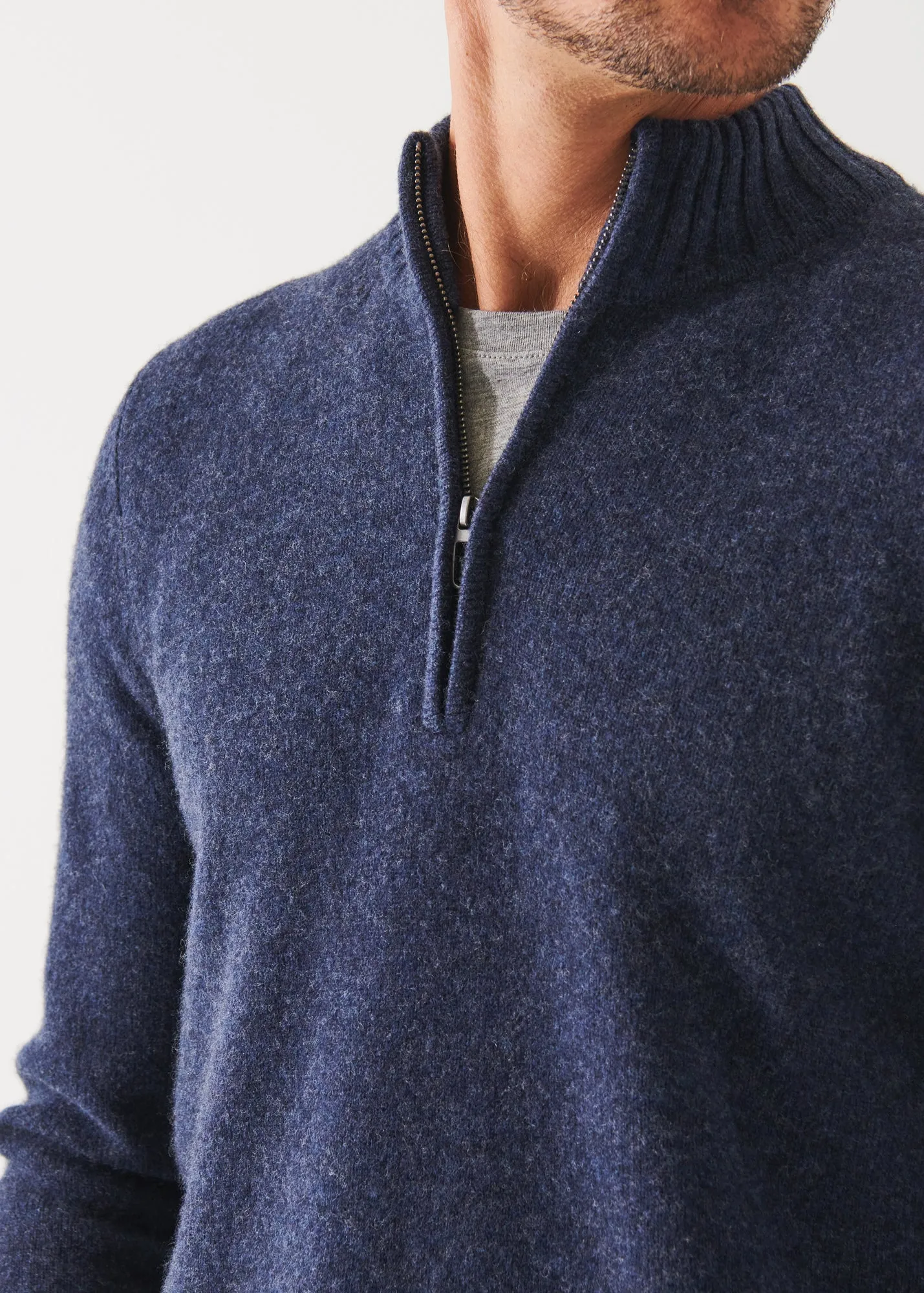 MERINO QUARTER ZIP SWEATER